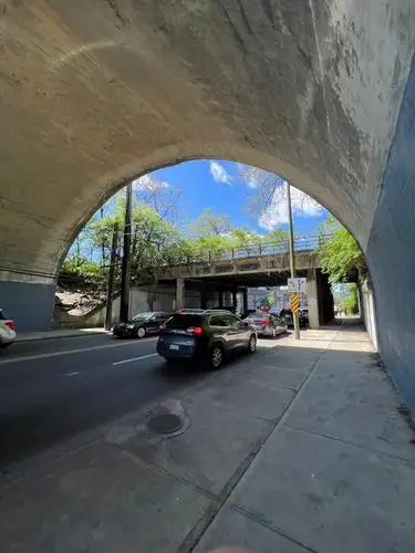 Concrete arch frames the rhythm of city life.